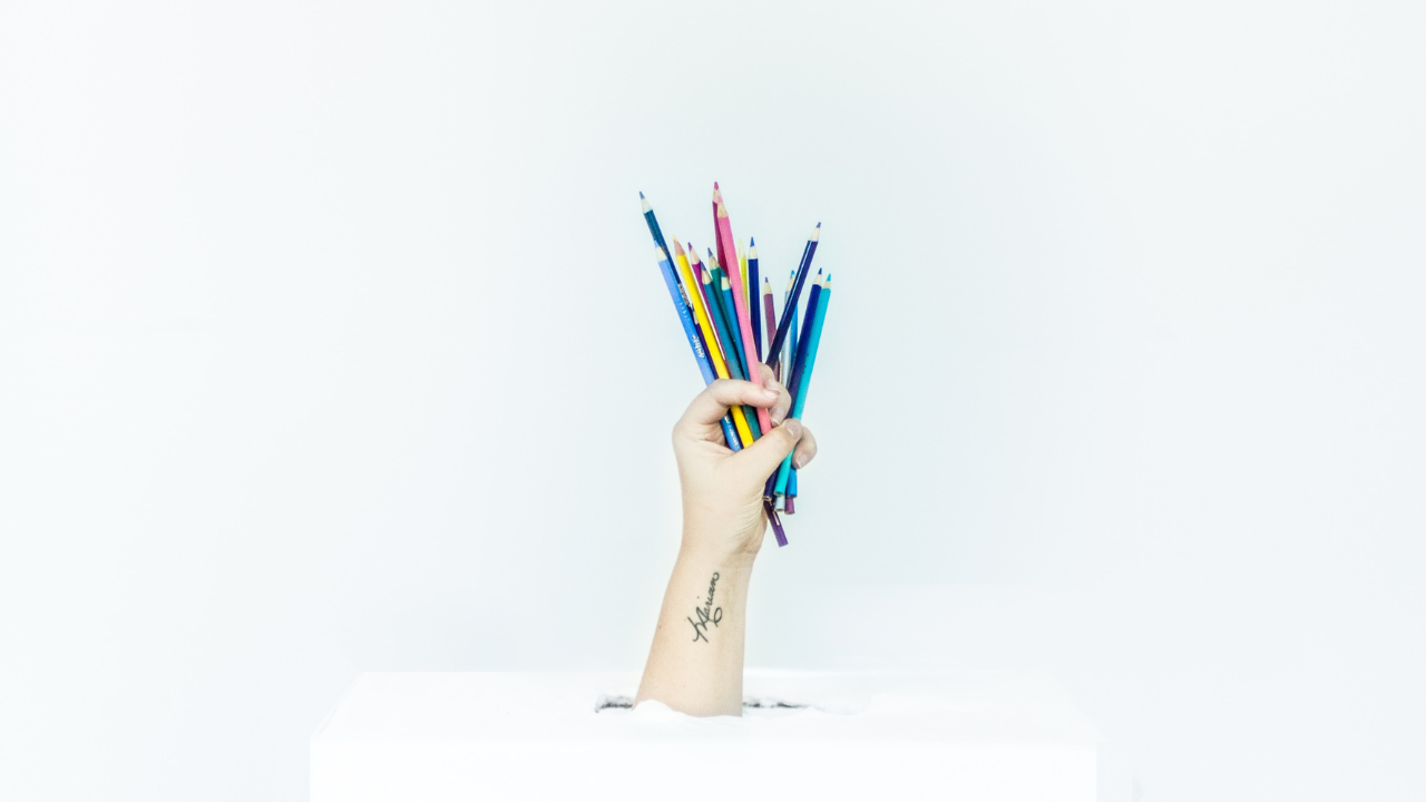 a hand that holds pencils